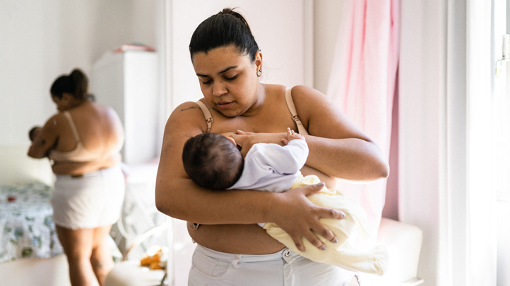 mom breastfeeding infant at home