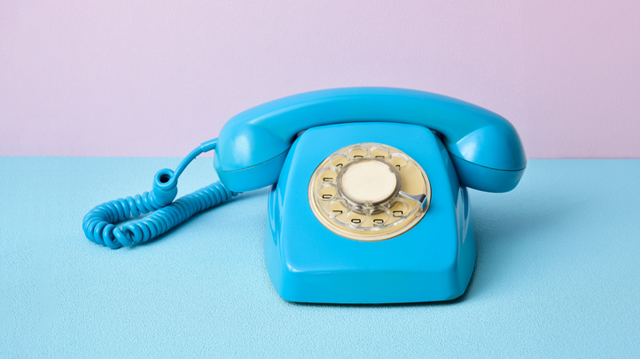 gender test kits, baby blue rotary telephone on baby pink background