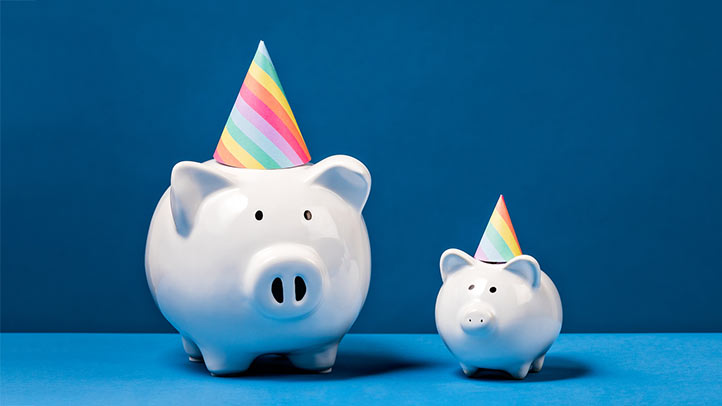 birthday party cost, two white piggy banks wearing colorful party hats on a blue background