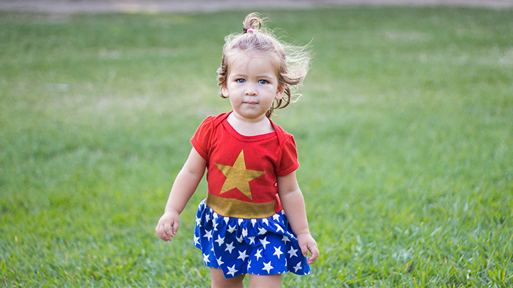 strong baby girl smiling with head up on arms