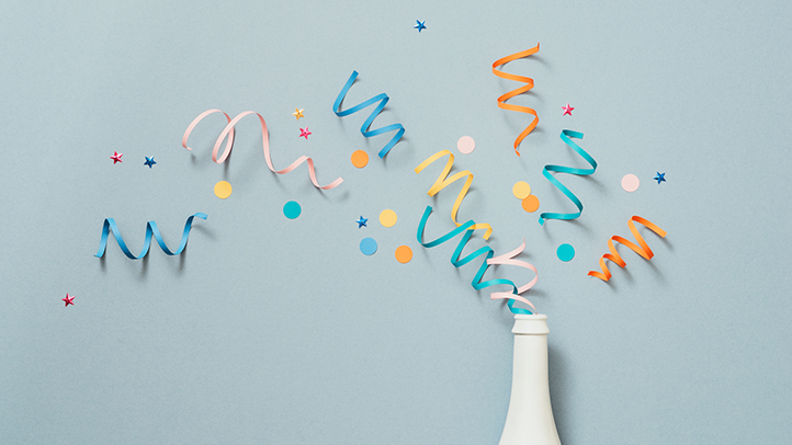 confetti popping out of white bottle