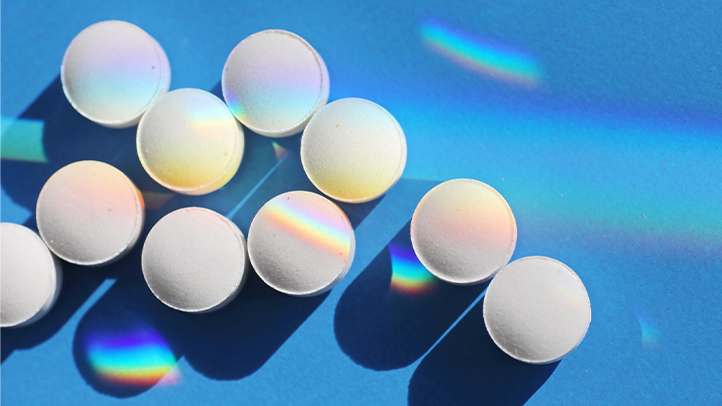 clomid, white pills on blue background