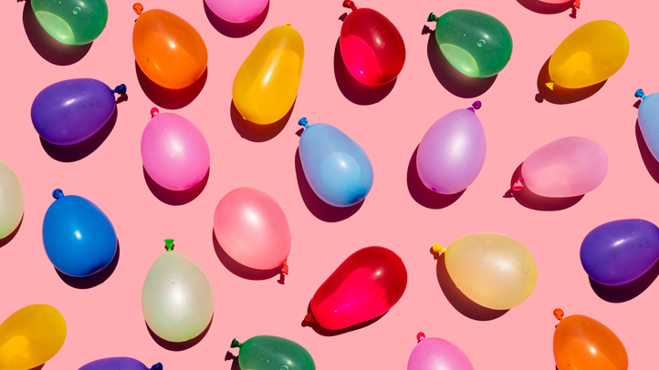 colorful water balloons on a pink background