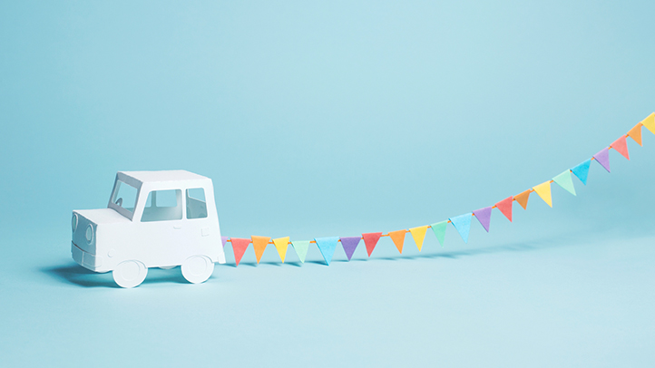 white paper car with a streamer behind it