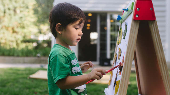 fall crafts for kids, toddler painting fall leaves outside