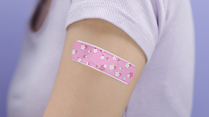 woman with vaccine bandage on arm, rsv vaccine for pregnant women approved