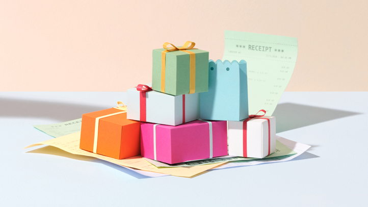pile of colorfully wrapped presents on top of a receipt