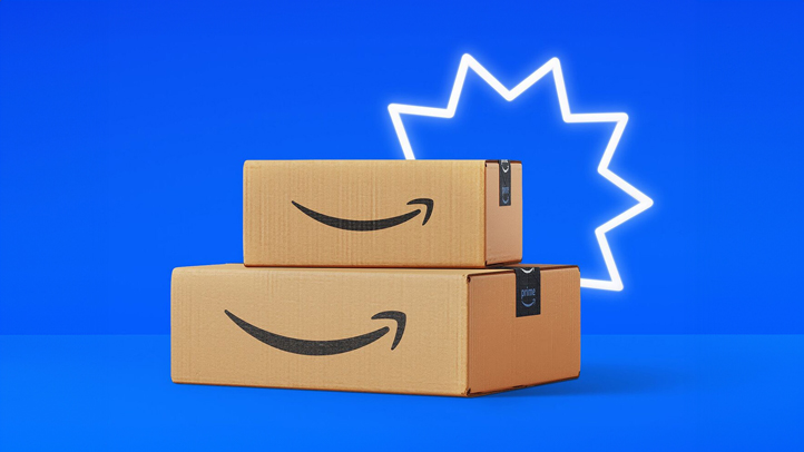 Two Amazon cardboard boxes stacked on top of each other on blue background