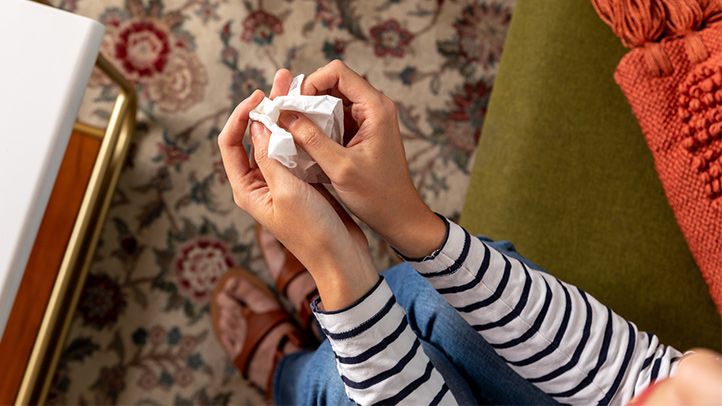 how to tell someone you have ppd, woman holding tissues