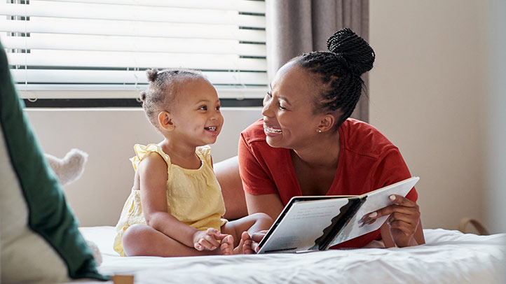 teaching your toddler the ABCs, little toddler girl and mom reading to her
