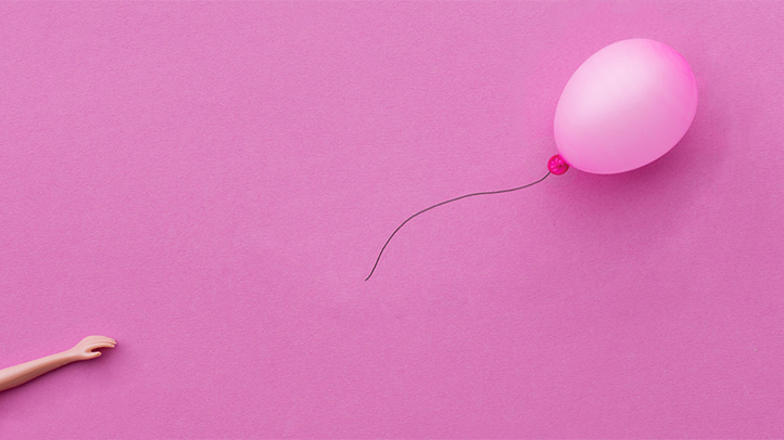 Light pink balloon on a darker pink background