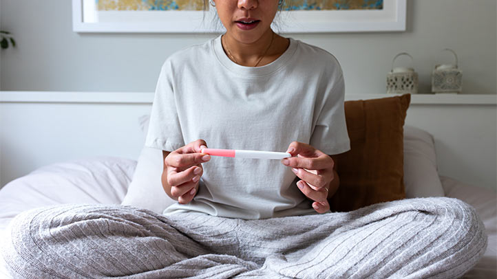 woman taking pregnancy test, ozempic babies, weight loss shots fertility