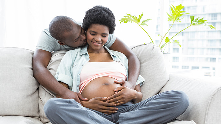 pregnancy symptoms for partners, man embracing pregnant woman