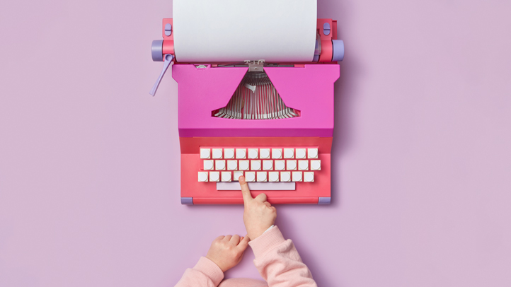 developmental delays, toddler hand pushing keys on a typewriter