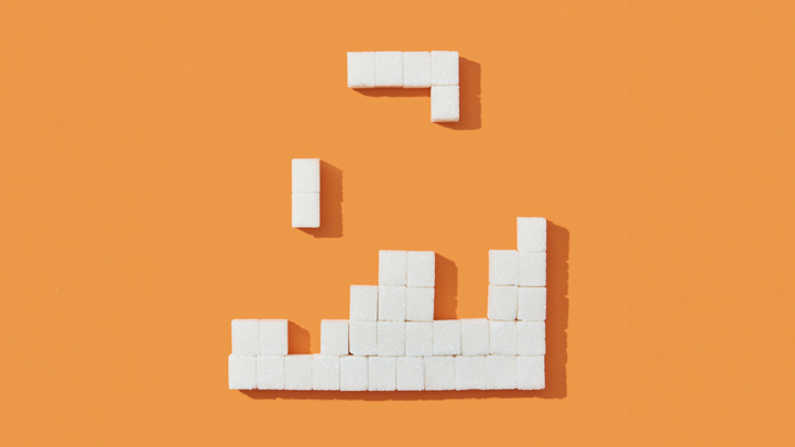 how to pass your glucose test; sugar cubes in Tetris shapes on an orange background