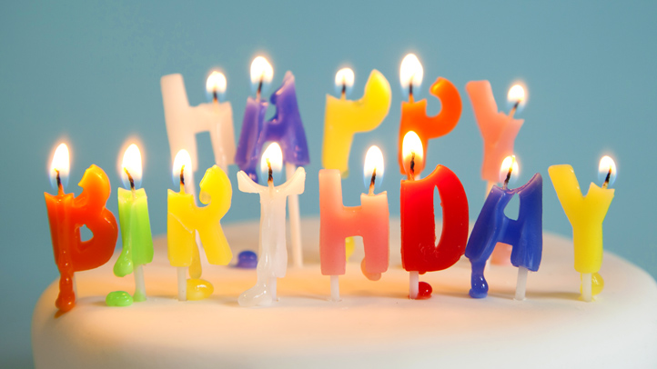 melting birthday candles on top of a white cake